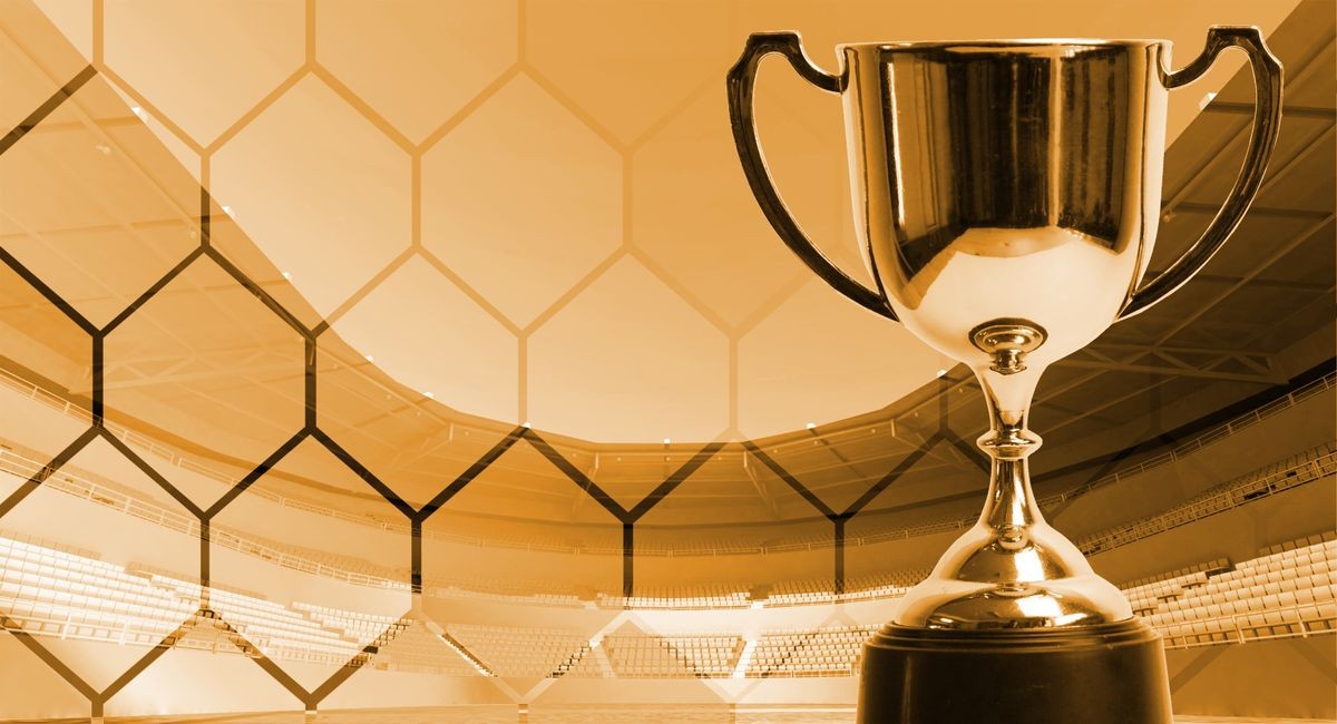Gold theme trophy with background fade hexagon pattern on stadium,win concept.
